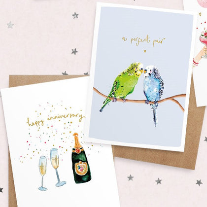 Four decorative cards on a pink background. Each card features colorful illustrations with floral themes and romantic quotes about love and beauty.