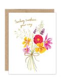 The Biely & Shoaf Sending Sunshine - Luxe Thinking Of You Card features a watercolor bouquet of pink, red, and yellow flowers tied with twine and gold foil cursive text. Part of the A2 Luxe Collection with brown envelope included.