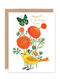 The Marigold Garden - Luxe Birthday Card by Biely & Shoaf features gold foil, orange flowers, a yellow bird below, and a green butterfly above, with "Happiest of Birthdays to you" in gold script. Includes a brown envelope.