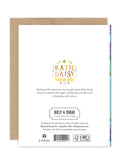 The back of the Lilacs Luxe Birthday Card by Biely & Shoaf displays Katie Daisy's name with floral accents, her bio, and publisher info—all part of our eco-friendly line—plus certification logos and a barcode below.