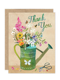 The Biely & Shoaf Watering Can Luxe Thank You Card features “Thank You” in green and blue, with a green watering can of flowers, butterflies, a bee, a ladybug, and scissors on textured eco-friendly stationery.