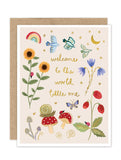 The Biely & Shoaf "Welcome To The World Luxe Baby Card" features whimsical gold foil flowers, mushrooms, strawberries, butterflies, birds, a snail, rainbow, moons, and stars with “welcome to the world little one” in gold text.