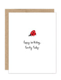 The Ladybug Luxe Birthday Card by Biely & Shoaf features a simple red ladybug above the handwritten message "happy birthday lovely lady" on a white background, paired with a brown envelope.