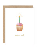 The Biely & Shoaf Make a Wish Cupcake Luxe Birthday Card features a pink-frosted cupcake with sprinkles, a lit green-striped candle, gold foil sparks, and "make a wish" in gold beneath. From the A2 Luxe Collection.