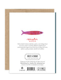 The back of the Sardines Luxe Birthday Card by Biely & Shoaf features a small pink and purple fish, artist bio, publisher info, and eco-friendly logos on white—part of our A2 Luxe Collection of sustainable stationery.