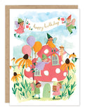 Cheerful fairies celebrating with balloons and a happy birthday banner around a pink spotted mushroom house, surrounded by yellow flowers—Emma Block–style art adorns Biely & Shoaf’s Fairies Birthday Card, ideal for a gold foil greeting.