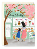The Patisserie Mother's Day Card by Biely & Shoaf features an Emma Block-style illustration of a woman and girl admiring cakes through a bakery window framed by pink blossoms, with "Happy Mother's Day" above.