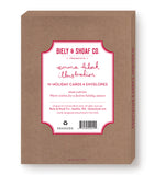 Box of Biely & Shoaf Dogs Making Spirits Bright holiday cards and envelopes featuring festive dog illustrations. The brown box includes a label with red and black text: “Warm wishes for a festive holiday season.”.