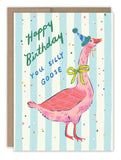The Silly Goose Birthday Card by Biely & Shoaf features a pink goose in a blue birthday hat and green bow on a striped blue and white background with confetti, plus gold foil details and the message: “Happy Birthday You Silly Goose.” Illustration by Emily Taylor.