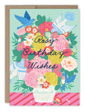The Biely & Shoaf Rosy Wishes Birthday Card features colorful flowers in a white vase with blue birds, gold foil accents, and “Rosy Birthday Wishes” in cursive on a light blue background—printed on FSC-certified recycled paper.