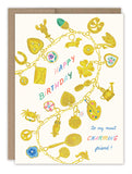 The Biely & Shoaf Charm Bracelet Birthday Card features a gold foil charm bracelet, colorful Happy Birthday text in the center, and to my most charming friend! in blue and pink script at the bottom right.