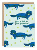 Blue dachshunds, yellow tennis balls on Biely & Shoaf’s Have A Ball Weenie Birthday Card—perfect for birthdays!.