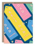 The Ribbons Best Dad Award Father's Day Card by Biely & Shoaf features colorful prize ribbons labeled "Best Dad Award" or "Dad Award" on a blue background, illustrated by Emily Taylor and printed in the USA.