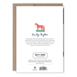 The back of the Ribbons Best Dad Award Father's Day Card by Biely & Shoaf shows a red horse, Emily Taylor’s name with a short bio, publisher details, “printed in the USA,” and comes with a brown envelope partially visible behind the card.