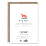 Back of Golf Father's Day Card by Biely & Shoaf shows a red horse above Emily Taylor's name, brief artist bio, company info, barcode, and “printed in the USA.” A brown envelope is partially visible behind the card.