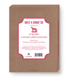 A brown box labeled Biely & Shoaf Laughing All The Way Boxed Holiday Cards features a festive front design, gold foil accents, product details, and holiday greeting on the cover.