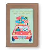 The Biely & Shoaf Penguin & Polar Bear Boxed Holiday Cards (Set of 10) features a bear and bird in a red car with gifts, gold foil accents, and the message: It’s the most wonderful time of the year.