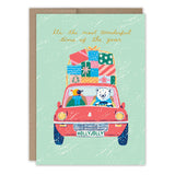 The Penguin & Polar Bear Wonderful Time Holiday Card by Biely & Shoaf features a bear and a bird in a red car with stacked gifts and a HOLLYJOLLY license plate, plus the message, “It’s the most wonderful time of the year.” Printed on recycled paper.