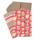 The Festive Cocktails Boxed Holiday Cards by Biely & Shoaf feature vibrant holiday drink illustrations on a red background, paired with brown envelopes. Each card is printed on recycled paper, perfect for sending festive cheer.