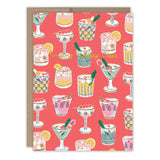 The Festive Cocktails Holiday Card by Biely & Shoaf features holiday cocktail illustrations on FSC-certified paper, a red background, and “Sending Holiday Cheer” in yellow script across the center.