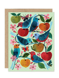 The Birds & Apples Notecard Set by Biely & Shoaf features six colorful birds among apples, flowers, leaves, and butterflies on a pale green background. Printed on FSC paper with a brown envelope. Ideal for boxed note sets.
