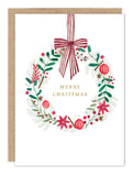 A wreath with red ornaments and a striped bow frames "Merry Christmas" in gold on this Biely & Shoaf holiday card.