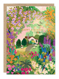 The Cottage Garden Birthday Card by Biely & Shoaf features a colorful cottage scene with vibrant flowers, trees, and grazing cows. Printed on FSC-certified recycled paper, it reads "Happy Birthday" above the cottage.