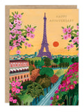 The Rooftops Of Paris Anniversary Card by Biely & Shoaf showcases Hebe Studio’s gold foil illustration of the Eiffel Tower at sunset, with pink flowers and lush gardens, and “Happy Anniversary” scripted in the sky.