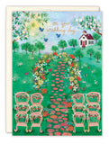 The Garden Scene Wedding Card by Biely & Shoaf features pink chairs on a flower-lined path leading to a white house, surrounded by trees, butterflies, and birds. Gold foil details highlight the On your wedding day message for an elegant touch.