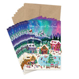 Aurora Magical Christmas cards by Biely & Shoaf show a snowy village, ice skaters, and festive white script on top.