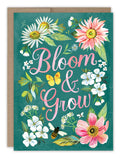 The Bloom & Grow Birthday Card by Biely & Shoaf features pink script, vibrant flowers, a butterfly, bee, and green leaves on a teal background—printed on FSC-certified recycled paper.