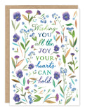 The All The Joy Wedding Card by Biely & Shoaf features a floral border in purple, blue, and green, inspired by Katie Daisy. The center reads: "Wishing you all the joy your hearts can hold." Printed on FSC-certified recycled paper.