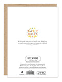 The back of the All The Joy Wedding Card features “Katie Daisy” in colorful floral letters, a description of her art style, and the Biely & Shoaf logo, plus copyright and FSC-certified recycled paper printing info at the bottom.