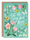 The Very Best Mom Floral Mother's Day Card by Biely & Shoaf features “To the very best Mom” in white script, surrounded by pink, yellow, and white flowers, butterflies, green leaves on a teal background. Includes a kraft envelope.