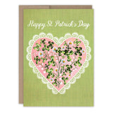 The Clover Heart St. Patrick's Day Card by Biely & Shoaf is a charming greeting card printed in the USA, featuring "Happy St. Patrick’s Day" above a pink lace-edged heart with clover and floral accents.