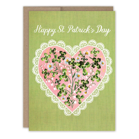 The Clover Heart St. Patrick's Day Card by Biely & Shoaf is a charming greeting card printed in the USA, featuring "Happy St. Patrick’s Day" above a pink lace-edged heart with clover and floral accents.