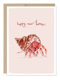 The Biely & Shoaf Hermit Crab New Home Card features a cheerful hermit crab in a spotted shell with "happy new home" in red, a beige border, and comes blank inside. Printed on recycled paper.