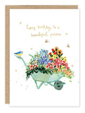The Biely & Shoaf Beautiful Person Birthday Card features a watercolor green wheelbarrow with colorful flowers, a bird on the handle, and gold "happy birthday to a beautiful person" text. Printed on recycled paper.
