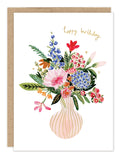 The Biely & Shoaf Vase of Flowers Birthday Card features a pastel pink vase with colorful blooms and "Happy Birthday" in gold cursive. Printed on premium recycled paper for an eco-friendly touch.