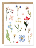 Pressed Flowers Birthday Card by Biely & Shoaf: "happy birthday" in cursive with floral border on recycled paper.