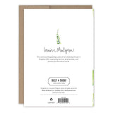 The back of the Snappy Father's Day Card by Biely & Shoaf features product info, a delicate green plant, and Louise Mulgrew’s signature, with a brown envelope partially visible behind the card.