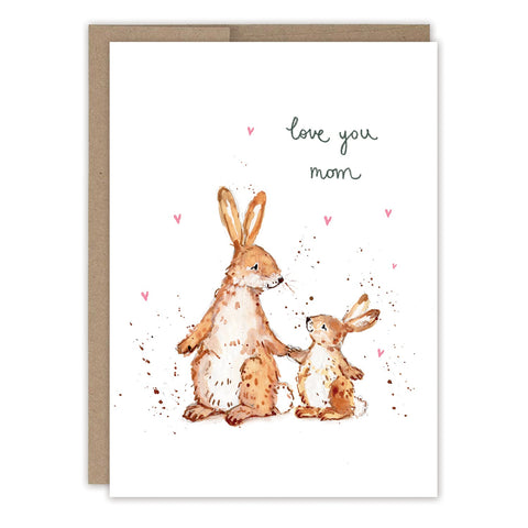 The Bunnies Mother's Day Card by Biely & Shoaf features a watercolor illustration of two brown rabbits, an adult and a child, with pink hearts and handwritten "love you mom" above them.