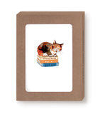 The Cat & Books Notecard Set by Biely & Shoaf features a watercolor of a brown cat on two books, including one titled Nothing Better Than a Good Book, in a simple cardboard frame—ideal for eco-friendly boxed notes.