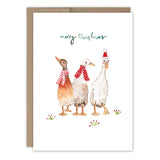 The Ducks Merry Christmas Holiday Card by Biely & Shoaf features three watercolor ducks in festive scarves and hats, with merry Christmas in gold foil above and holly sprigs on the ground.
