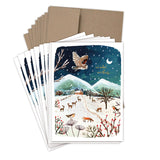 The Biely & Shoaf Owl Winter Countryside Boxed Holiday Cards (Set of 10) feature a snowy landscape with mountains, trees, deer, a fox, and an owl under a starry sky. Winter Wishes appears in gold foil on FSC-certified paper.
