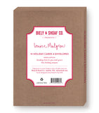 A brown box labeled “Biely & Shoaf Dove Peace On Earth Boxed Holiday Cards,” with red and white text, gold foil accents, and product details on the front, all crafted from recycled paper.