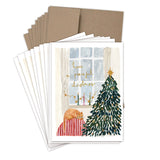 Biely & Shoaf Sleeping Cat Peaceful Christmas Boxed Cards are printed on recycled paper and feature a sleeping orange cat on a red-striped cushion, a decorated Christmas tree, and gold foil "have a peaceful christmas" by a window.