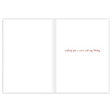 Open the Biely & Shoaf Sleeping Cat Peaceful Christmas Boxed Card to mostly blank white pages; on the right, red handwritten text says, “wishing you a warm and cozy holiday.” Printed on recycled paper for eco-friendliness.