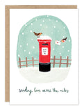 Send love afar with Biely & Shoaf's Mailbox Sending Love Holiday Card—festive art of birds, snow, and a red mailbox.