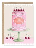 The Cherry Cake Birthday Card by Biely & Shoaf features a pink cake with white icing, cherries on top, and "Happy Birthday" written in icing—perfect for sending sweet birthday wishes.